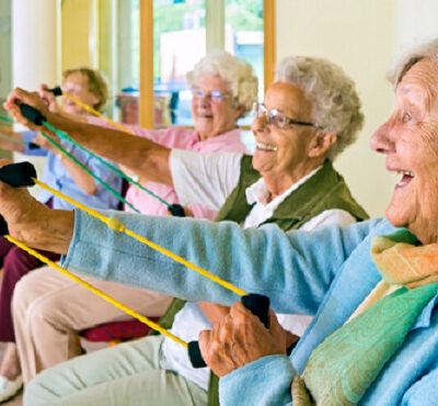 Elderly ladies exercising in a gym.