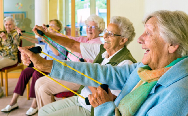 Elderly ladies exercising in a gym.